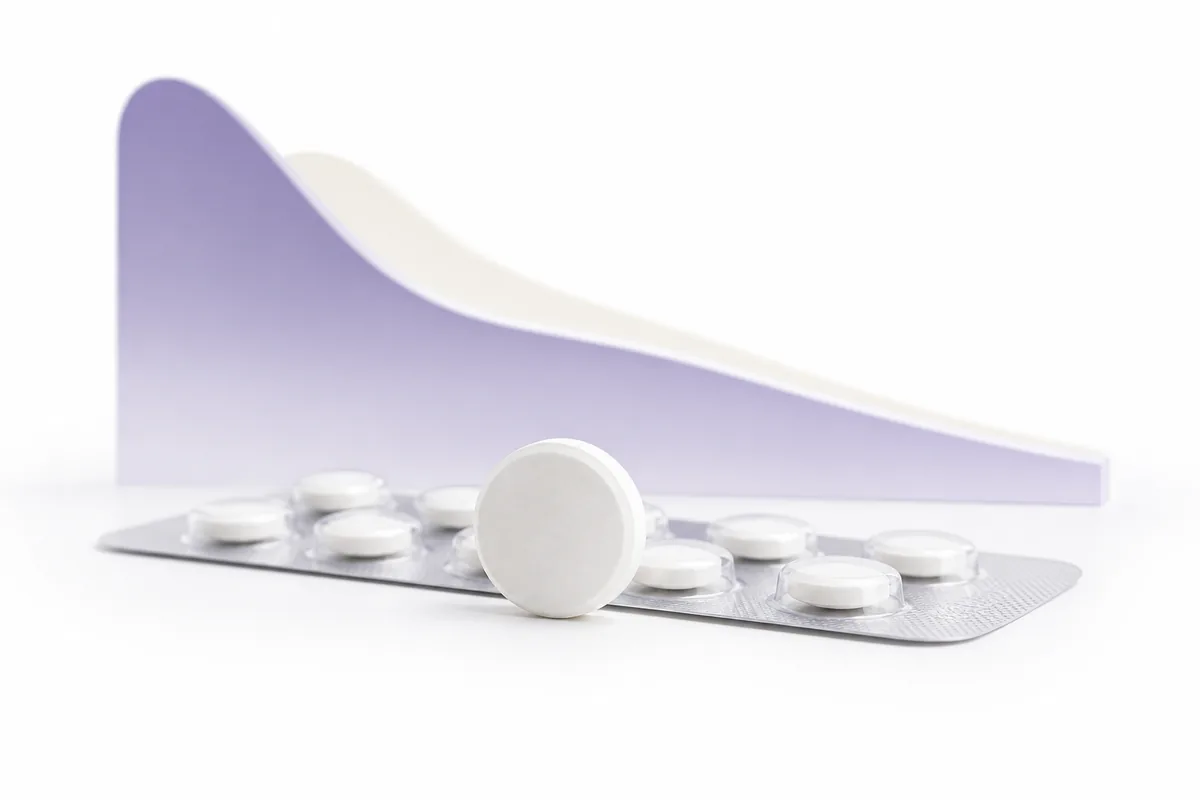 A white tablet standing on edge beside a blister pack with a descending appetite curve, illustrating oral semaglutide, the Wegovy pill